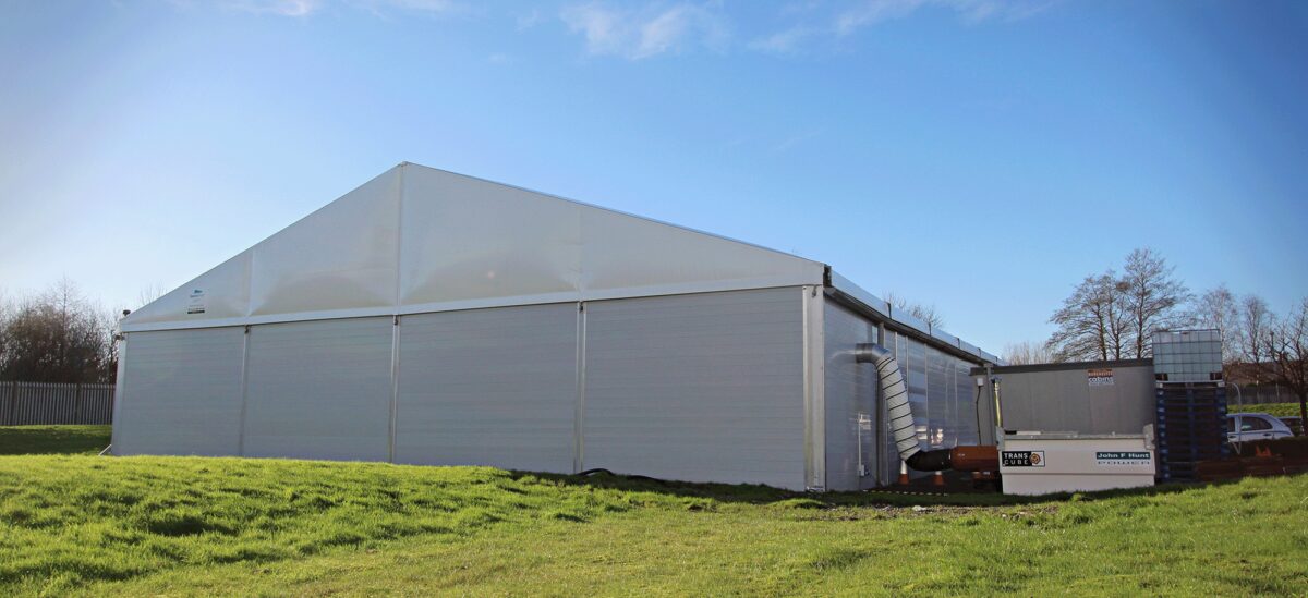 temporary building with in a field and connected HVAC system