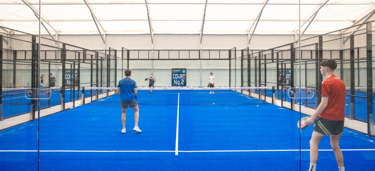 Temporary building with padel courts from the ground with people playing
