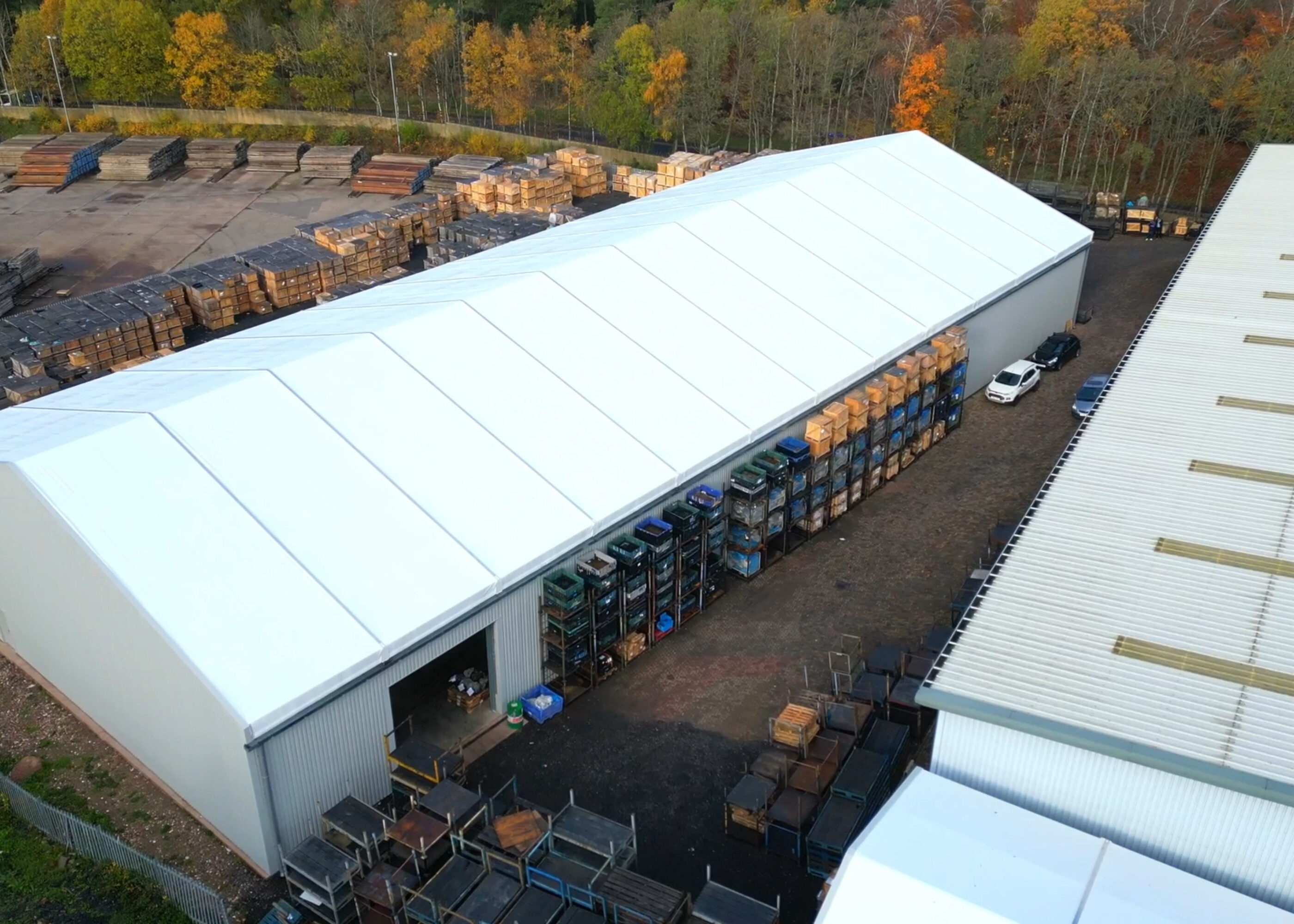 arial view of temporary building in white showing the roof width and length within a working yard