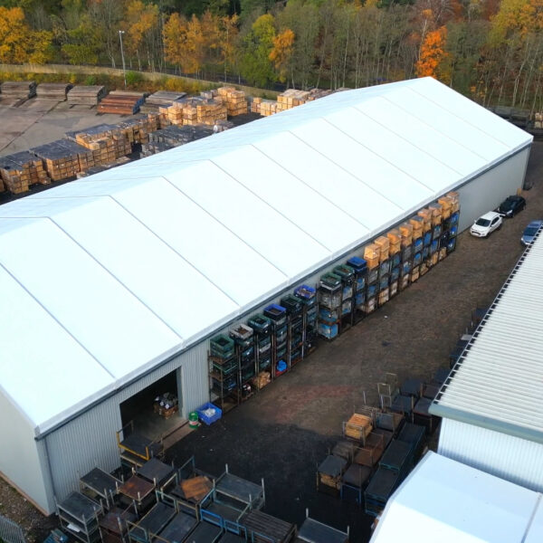 arial view of temporary building in white showing the roof width and length within a working yard