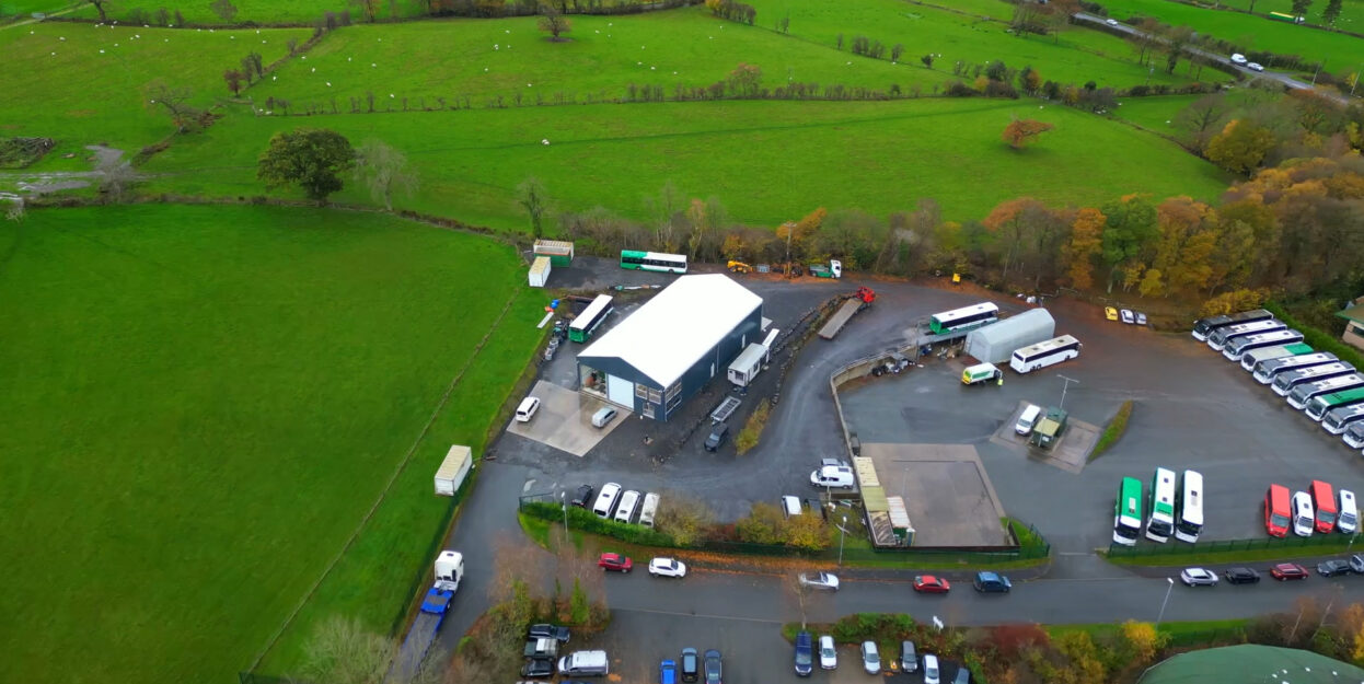 Overhead view of temporary building positioned next to a parking and green fields