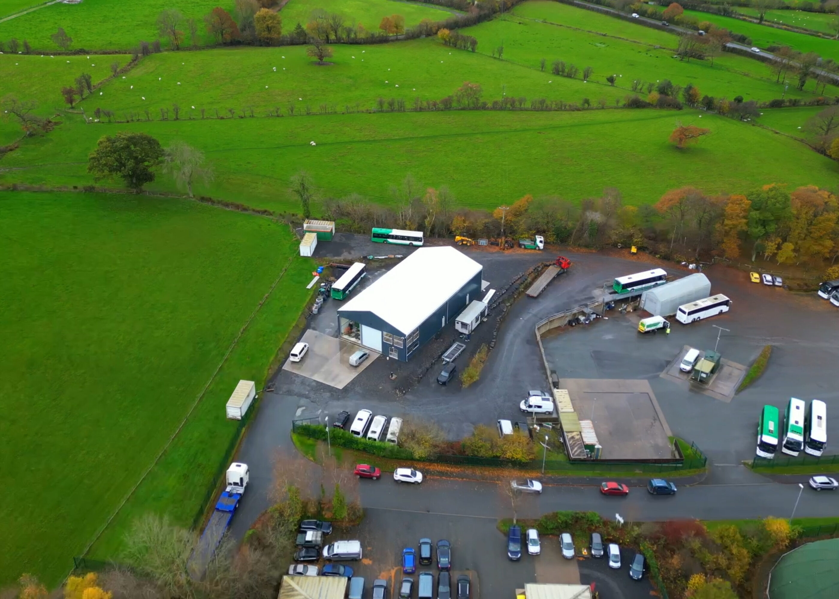 Overhead view of temporary building positioned next to a parking and green fields