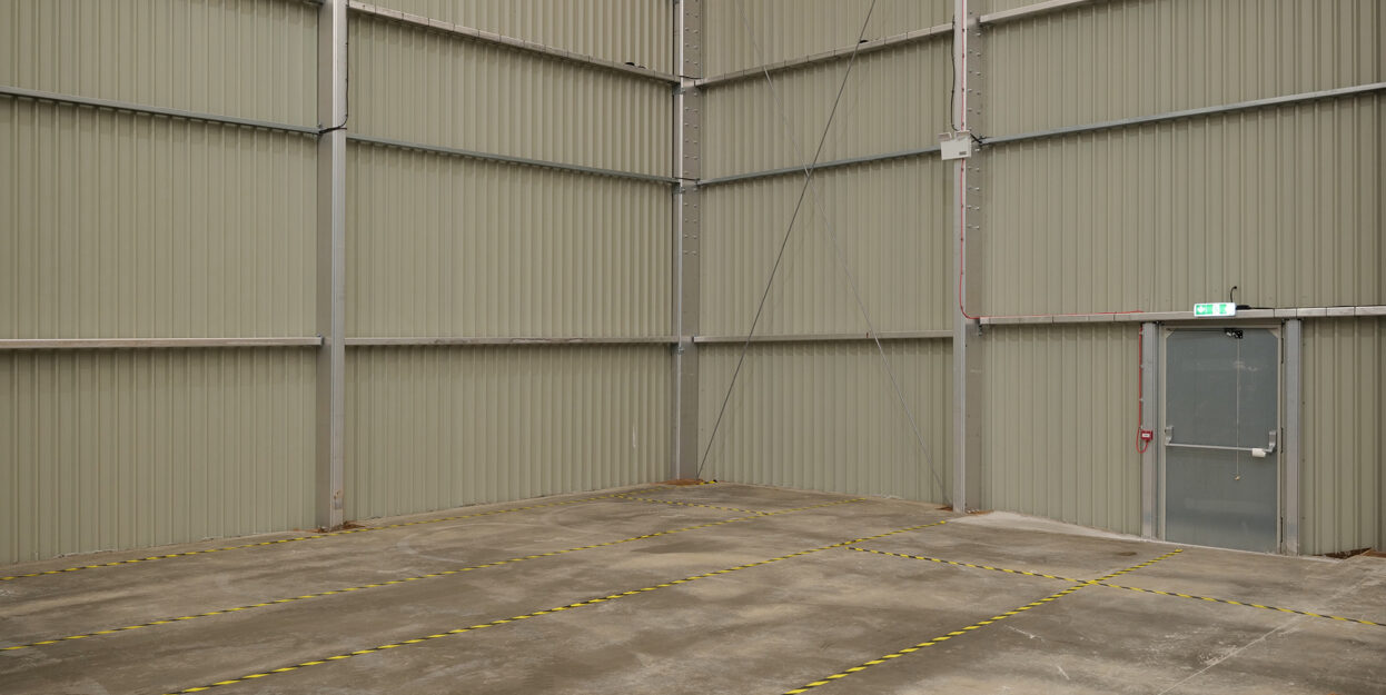 inside a warehouse corner with a pedestrian door