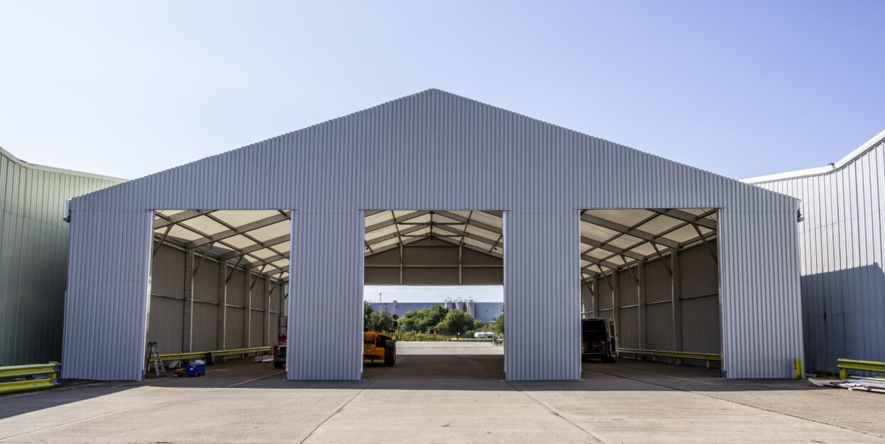 adapted in Situ, large open temporary building with three large open doors