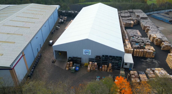 temporary Spaciotempo from above within a yard with many stock stored around the building