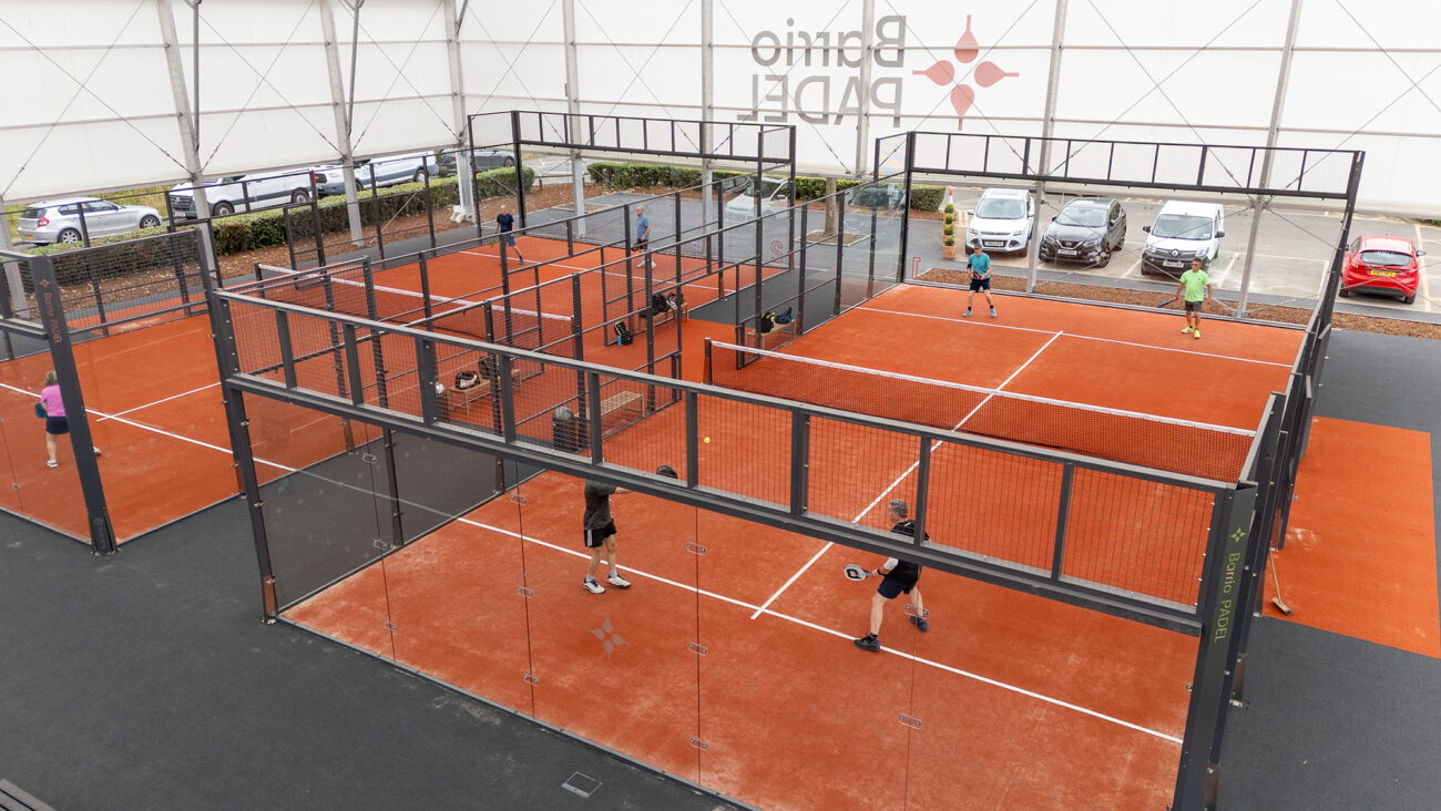view from above within the canopy looking at the padel courts with people playing