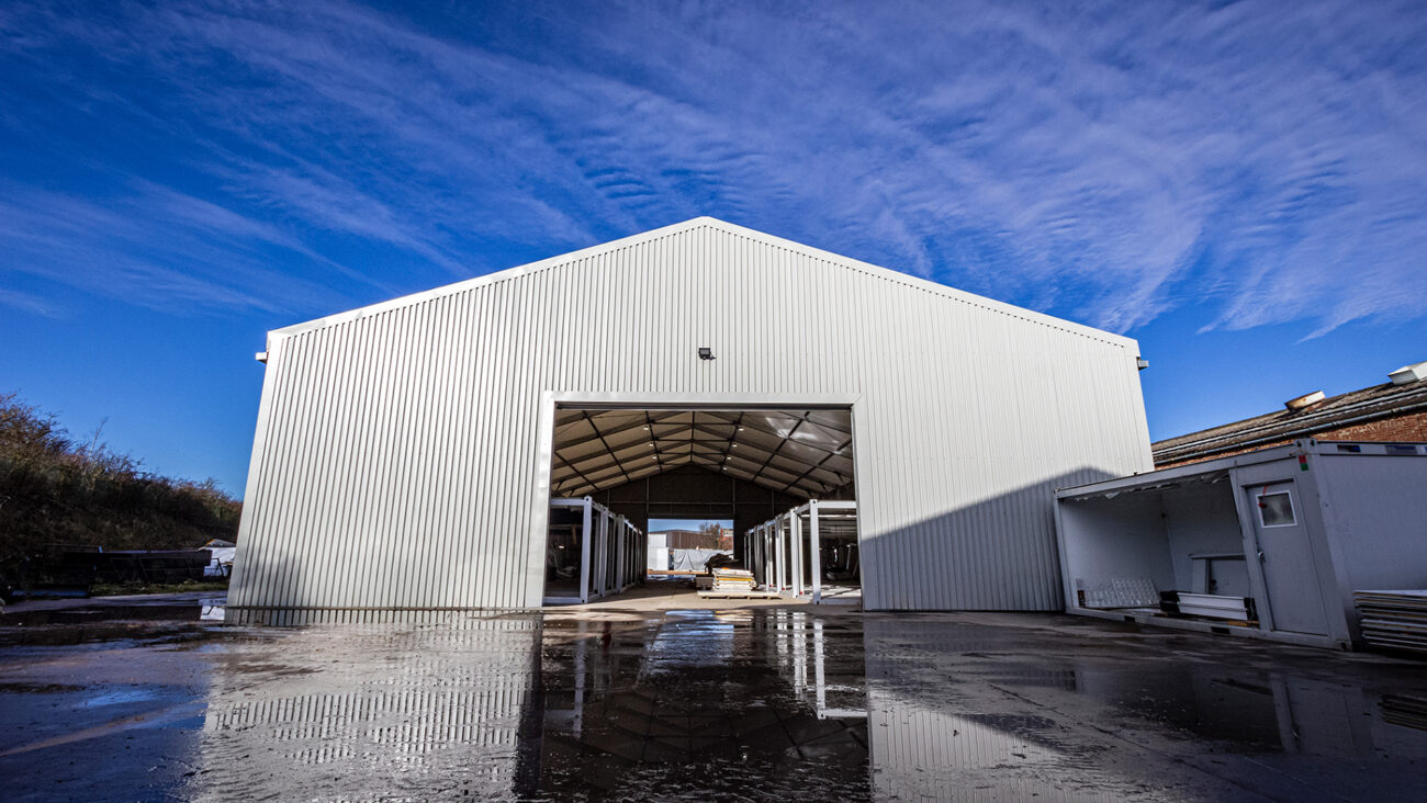Temporary building in a yard with rolling shutter door open