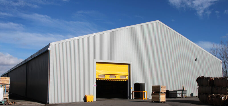 temporary warehouse within a yard with a yellow shutter door