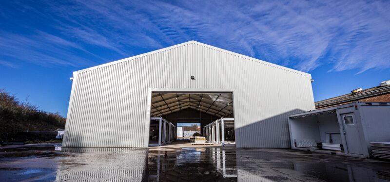 Temporary building in a yard with rolling shutter door open