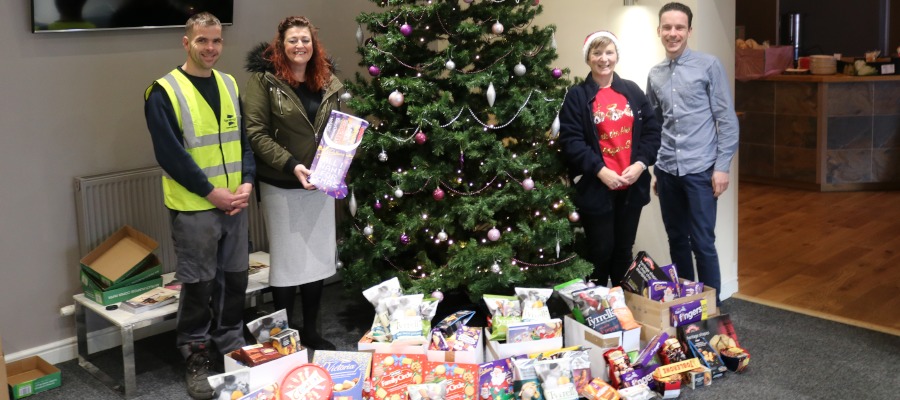 The Spaciotempo team presenting festive donations to Paul Jones at the Renew Church Food Bank in Uttoxeter.